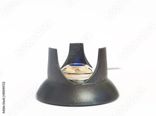 Alcohol burner in stand from a fondue set isolated on white back
