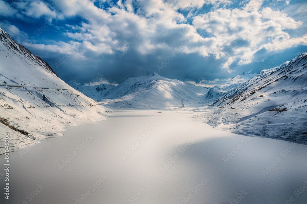 Alps in winter with snow and frozen lake