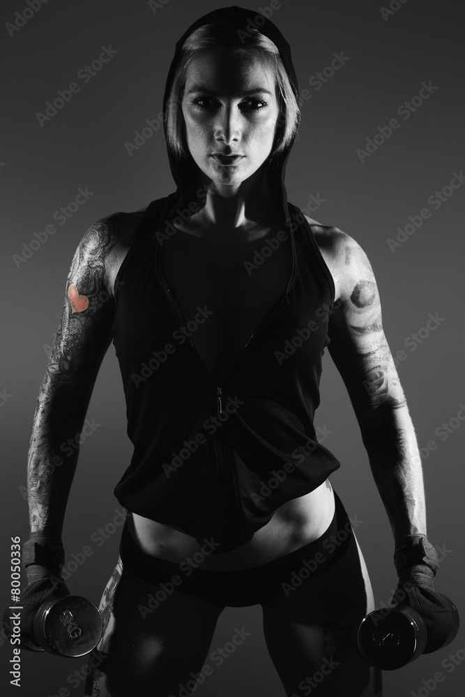 Black and white image of a young female fitness model posing. Black and white image of a young female fitness model posing.