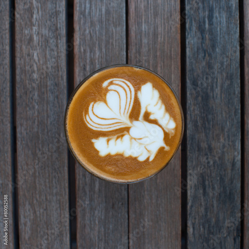 hot milk art coffee on wooden table