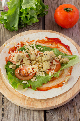 Tortilla with chicken, tomatoes, salad