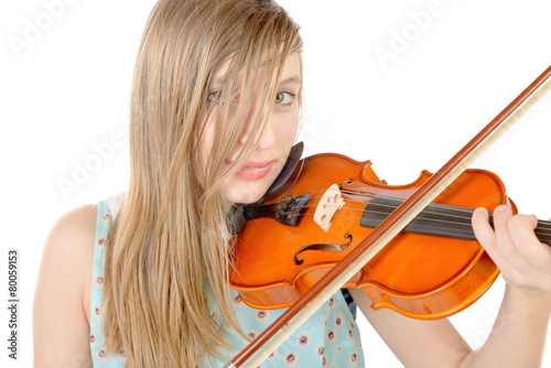 a teenage girl with long hair plays violin