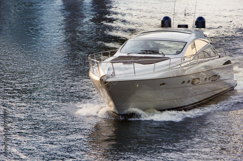 white motor boat on water at sunset photo