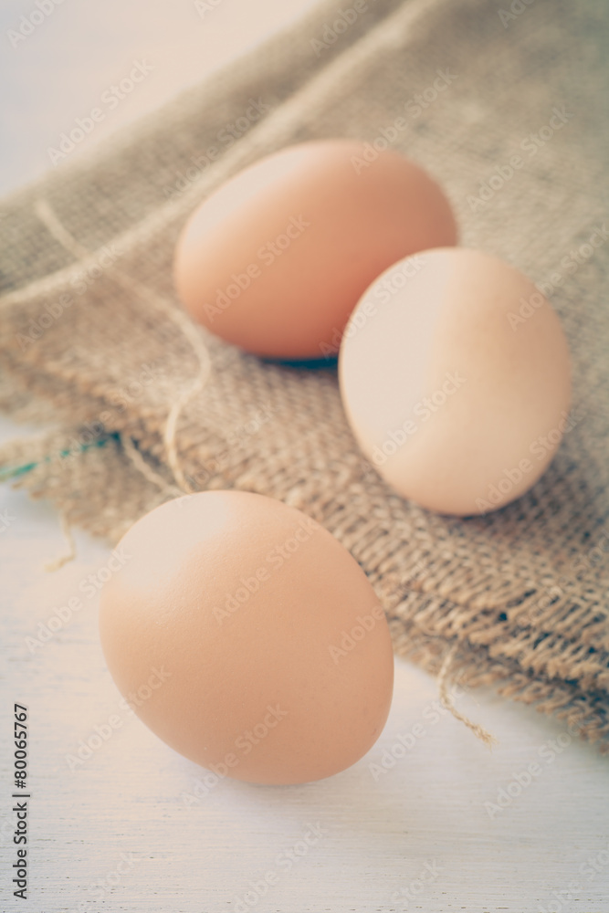 Healthy food brown chicken egg on brown fabric background Healthy food brown chicken egg on brown fabric background