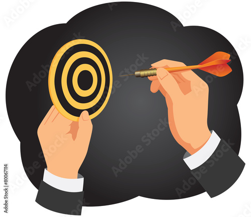 Hand with a dart is aiming at a dartboard on a dark background