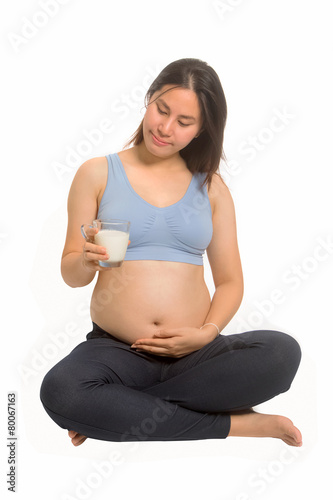 Happy pregnant woman drinking milk. Healthy eating