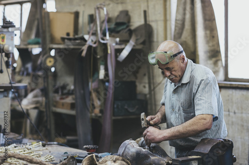 Senior artisan working in iron casting foundry