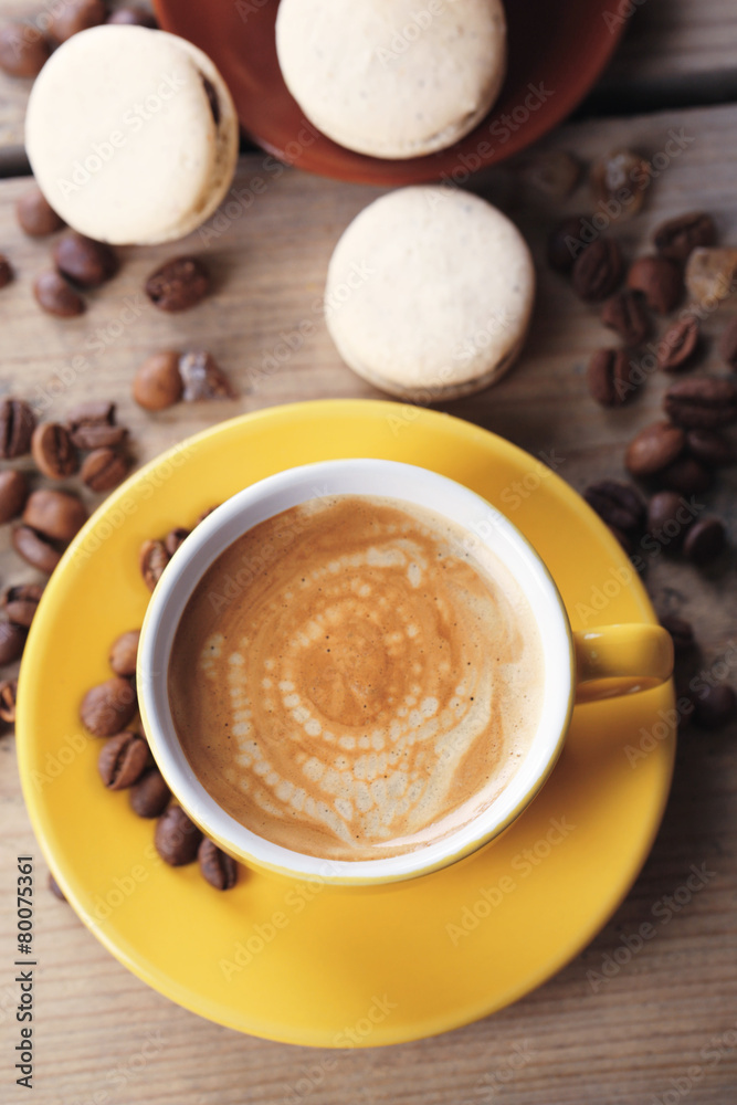 Gentle colorful macaroons and coffee in mug Gentle colorful macaroons and coffee in mug
