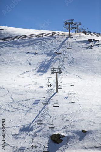 Ski chair lift with skiers. Ski resort in Sierra Nevada, Granada