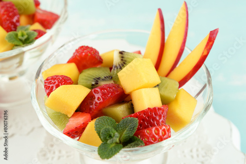 Fruit salad with mint in glassware