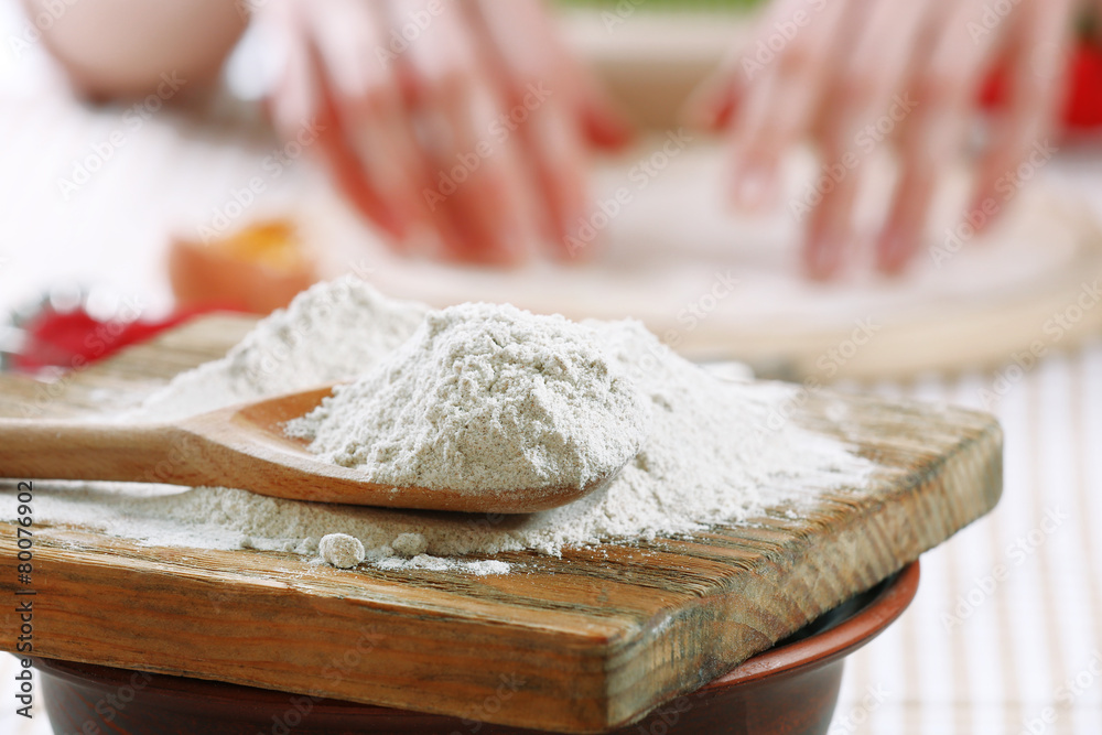 Young woman prepares dough on table close up Young woman prepares dough on table close up