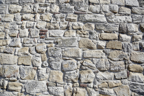 old gray stone wall of brick