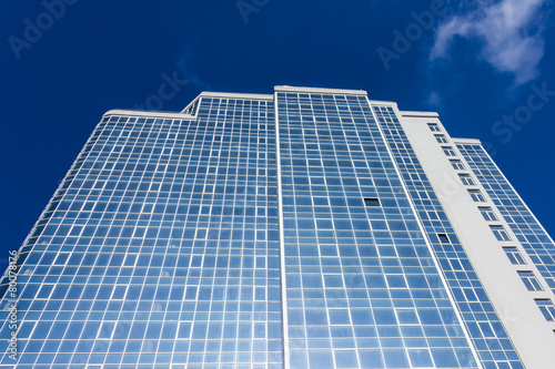 The glass facade of a tall building