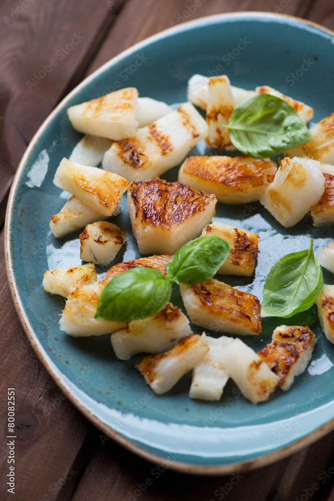 Close-up of grilled pineapple slices with green basil leaves Close-up of grilled pineapple slices with green basil leaves