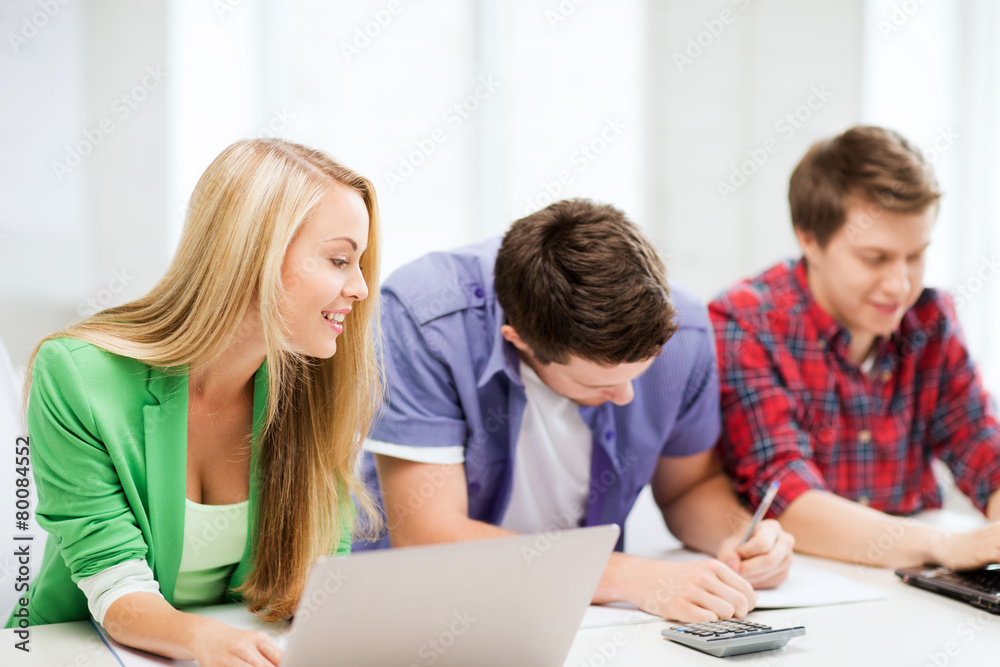 students writing test or exam in lecture at school students writing test or exam in lecture at school