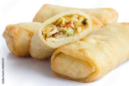 Fried chinese vegetable spring rolls on white surface.