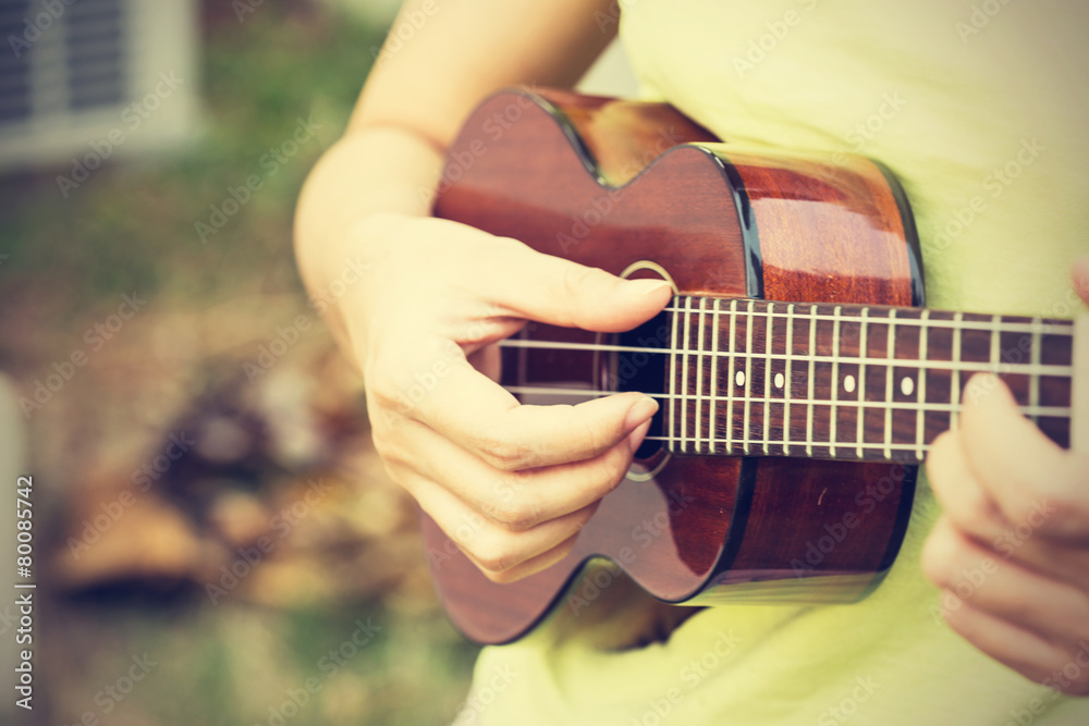 Fototapeta premium Woman playing ukulele, vintage style.