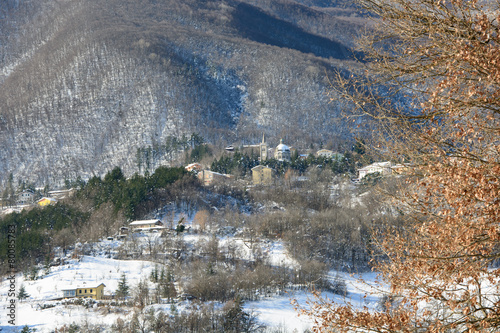 Mountain village covered with snow in a sunny day photo