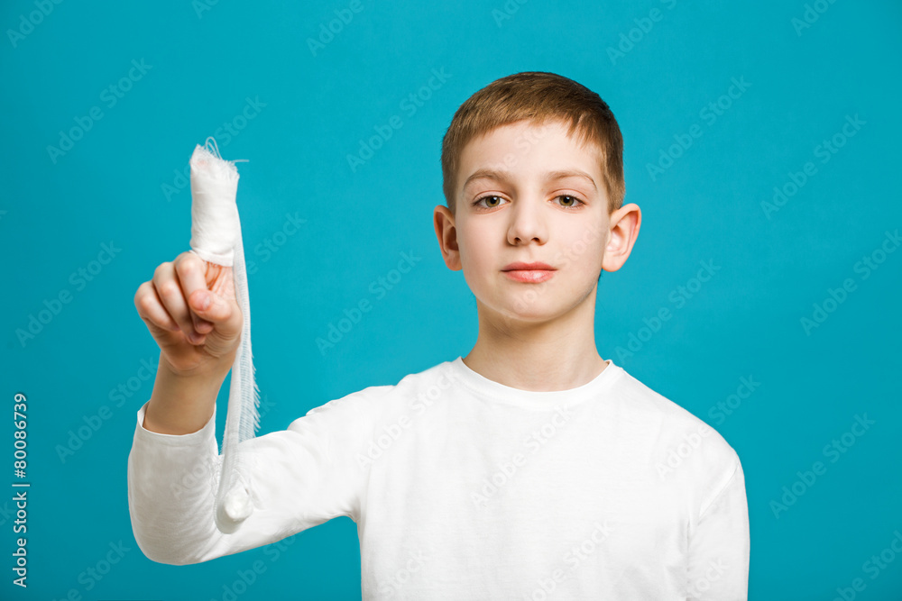 Portrait of a boy with medical bandage on his thumb Portrait of a boy with medical bandage on his thumb
