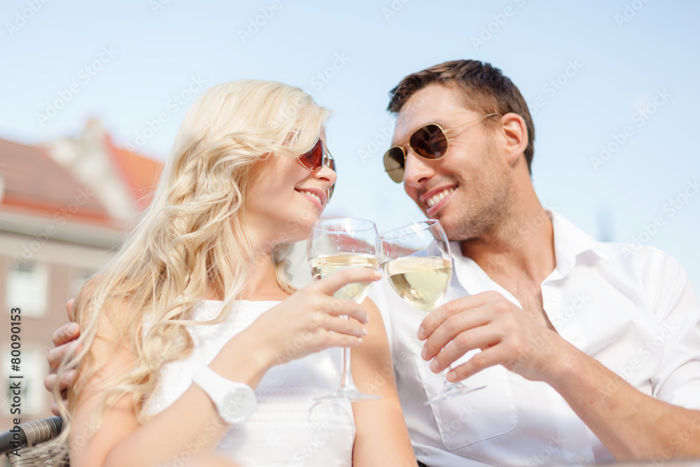 smiling couple in sunglasses drinking wine in cafe smiling couple in sunglasses drinking wine in cafe