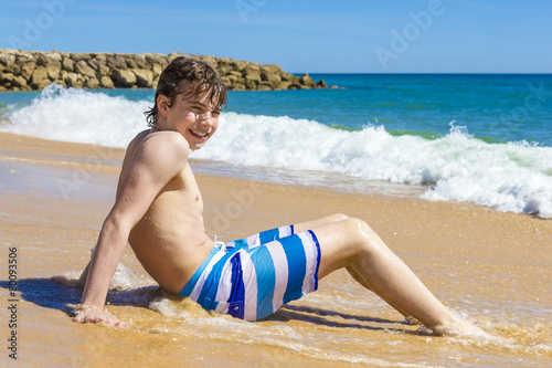boy is playing  in a beautiful sea