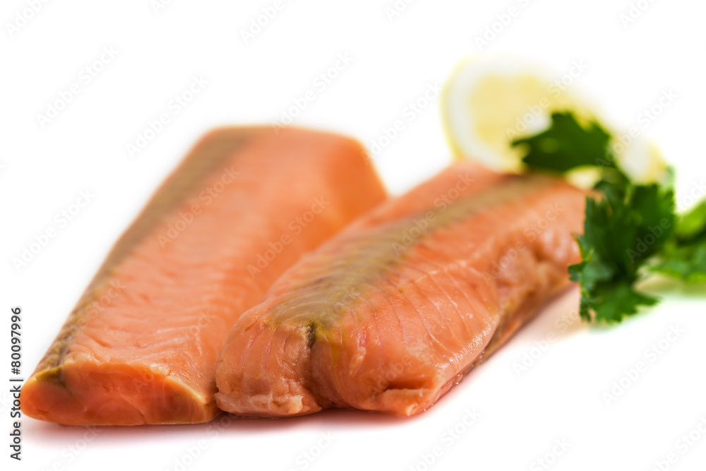 Raw salmon fillet with lemon and parsley isolated on white Raw salmon fillet with lemon and parsley isolated on white