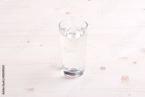 water in a glass and a napkin on the board