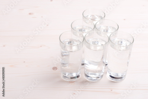 water in a glass and a napkin on the board