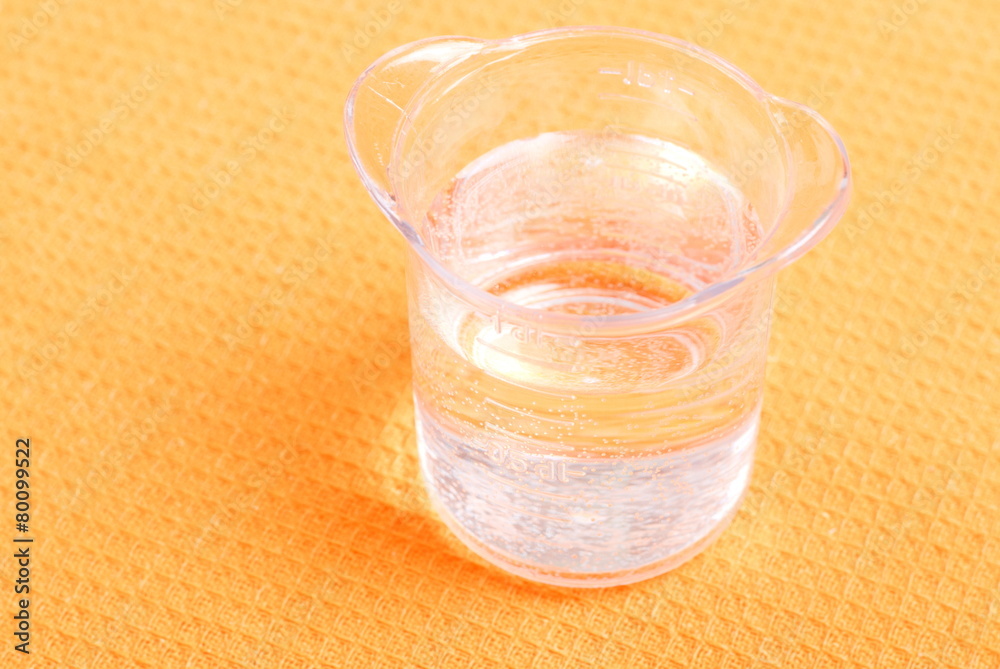 water in a glass and a napkin on the board water in a glass and a napkin on the board