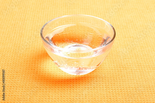 water in a glass and a napkin on the board