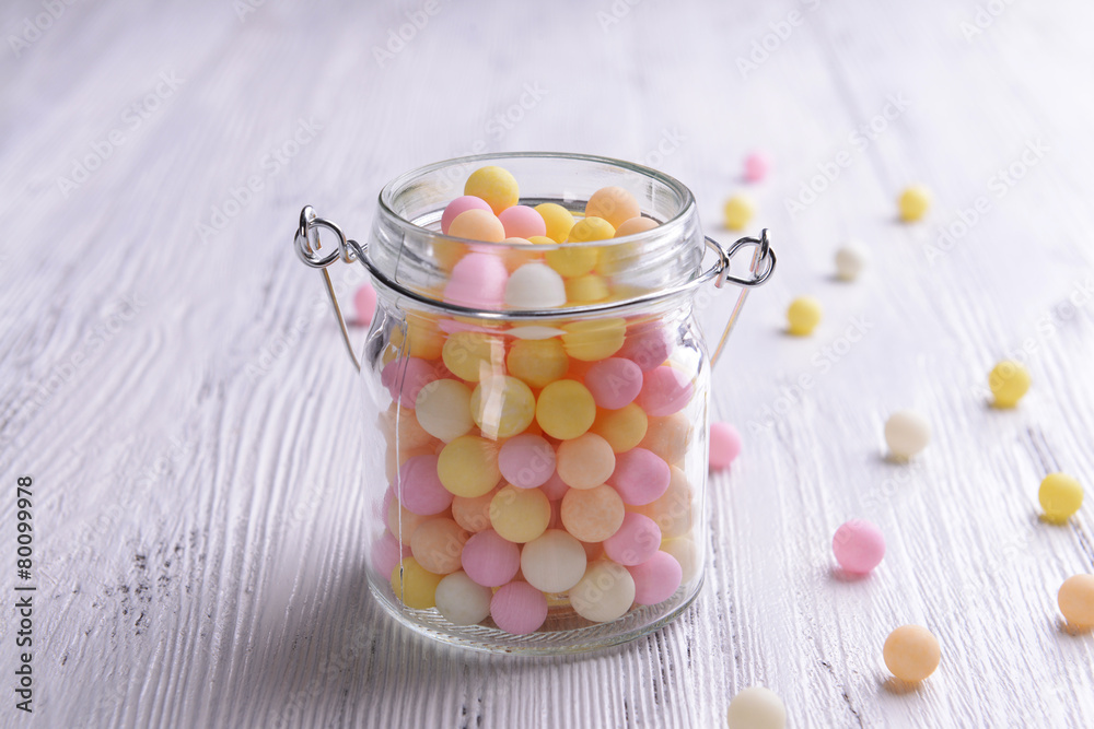 Colorful sprinkles on jar on table close-up Colorful sprinkles on jar on table close-up