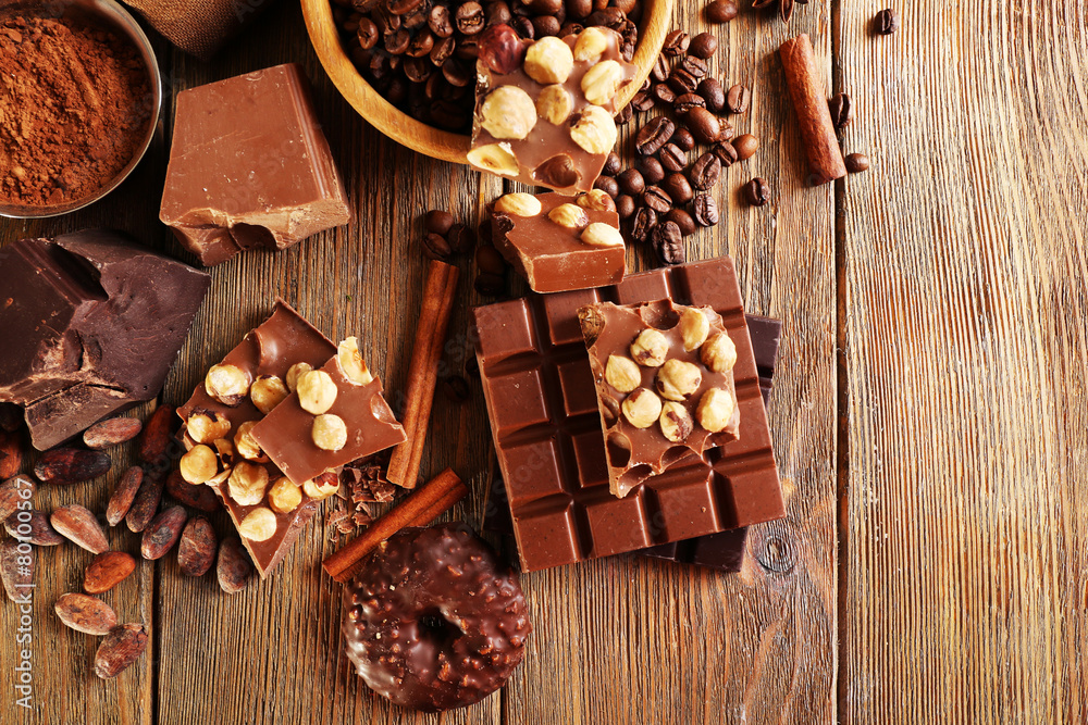 Still life with set of chocolate on wooden table, top view Still life with set of chocolate on wooden table, top view