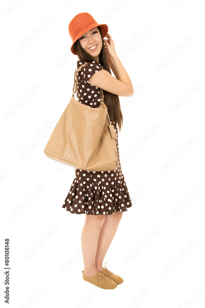 Cute teen model standing wearing polka dot dress smiling at came Cute teen model standing wearing polka dot dress smiling at came