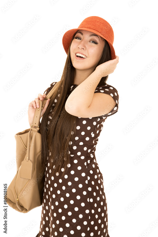 Confident teen girl model wearing a polka dot dress orange hat w Confident teen girl model wearing a polka dot dress orange hat w