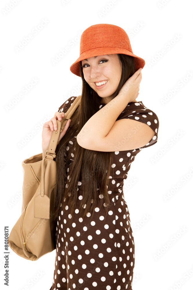 Smiling Asian American teen girl wearing brown polka dot dress Smiling Asian American teen girl wearing brown polka dot dress