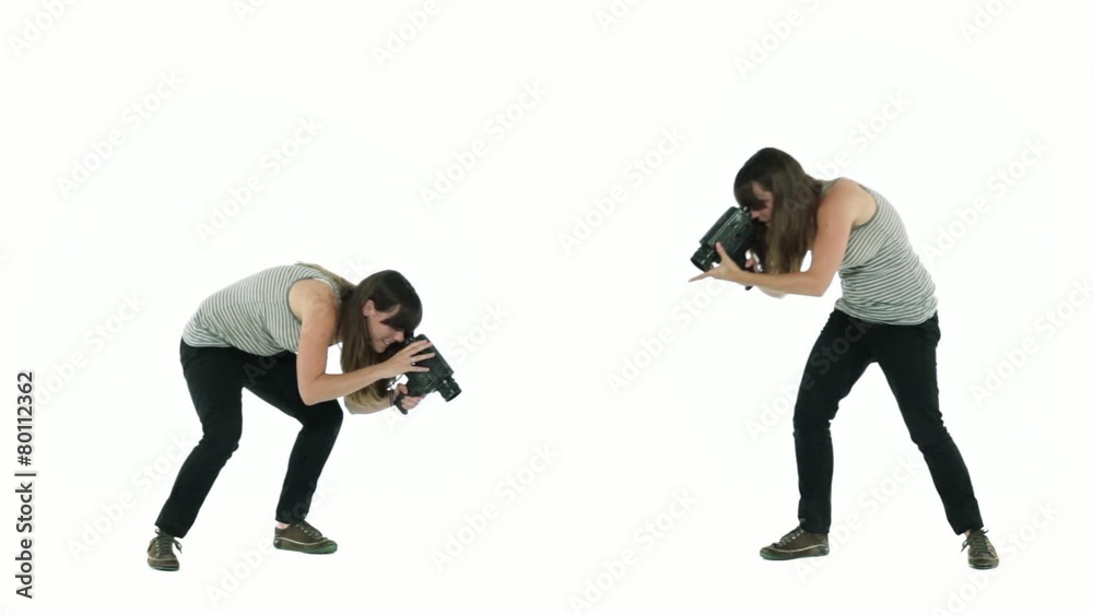 Two girls filming different angles of an unseen object in a white studio.. Two girls filming different angles of an unseen object in a white studio..