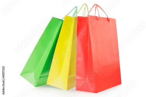 Red, yellow, green shopping bags on white, clipping path