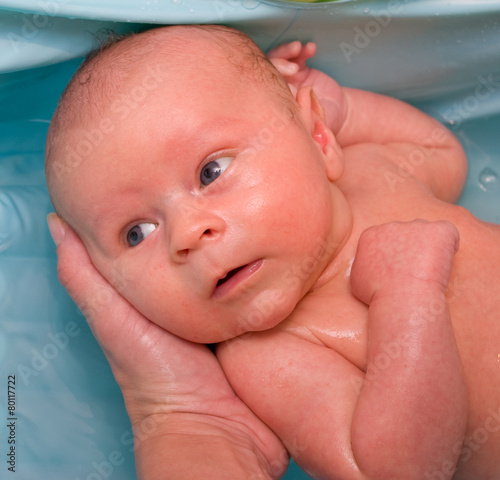 Newborn boy bathing