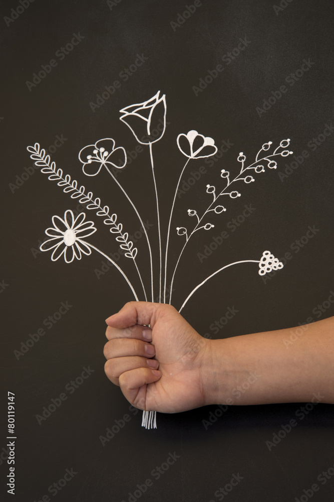 holding flowers on blackboard - obrazy, fototapety, plakaty 