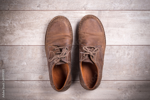 Brown men's shoes on a wooden background