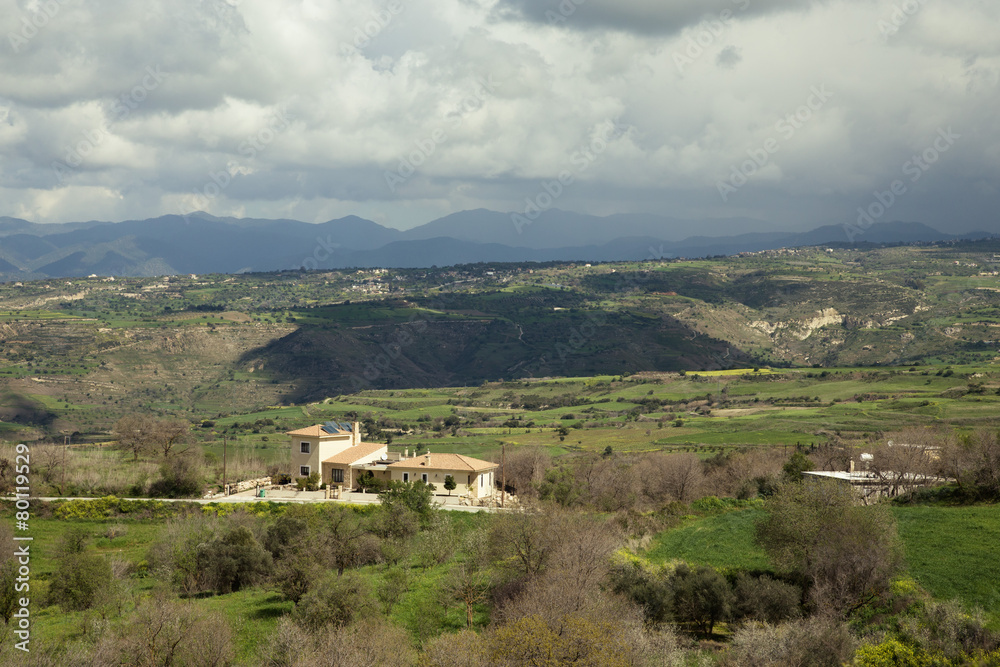 Stormy Mediterranean landscape with mountains, clouds, trees and