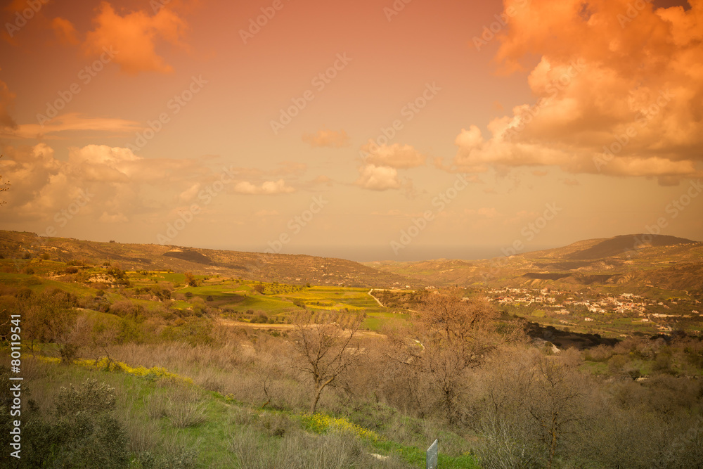 Idyllic Mediterranean landscape with mountains, clouds, trees an
