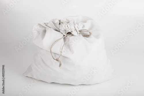 White linen bag with a rope on a light background