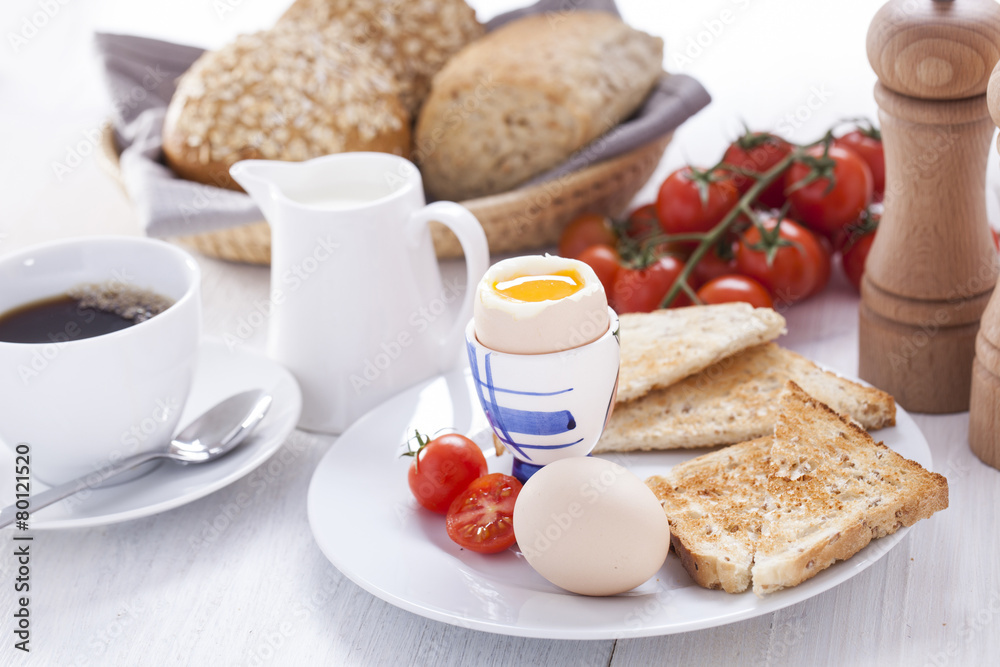 Soft-boiled egg in the morning with toast. In the background of