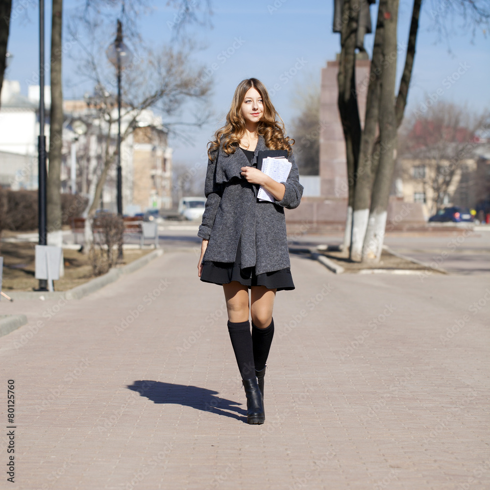 Schoolgirl walking on spring sunny street Schoolgirl walking on spring sunny street