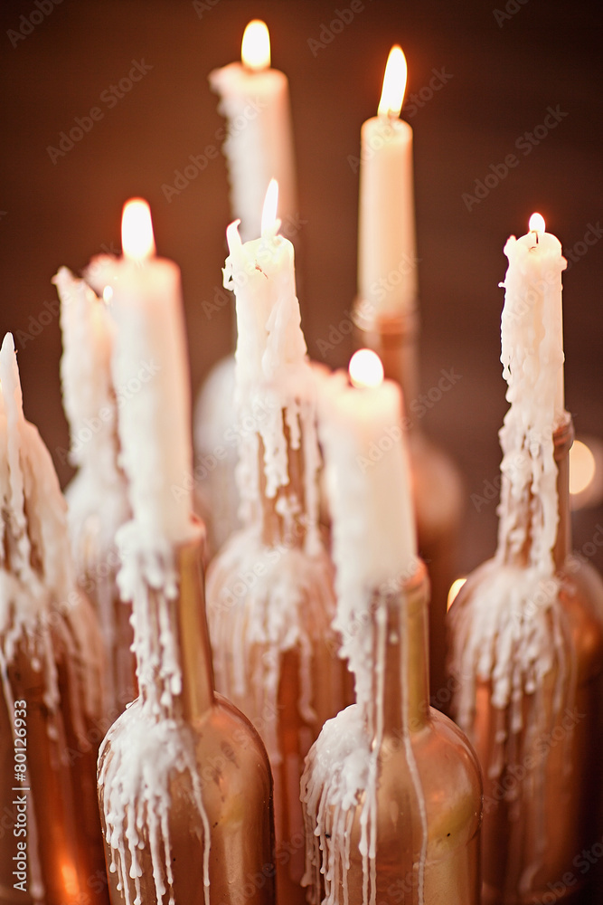 Gold bottle with burning candles Gold bottle with burning candles