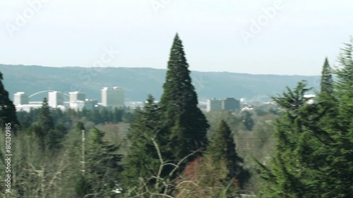 Camera pans and stops on a view of the city of Portland, Oregon, looking west from Mt Tabor.