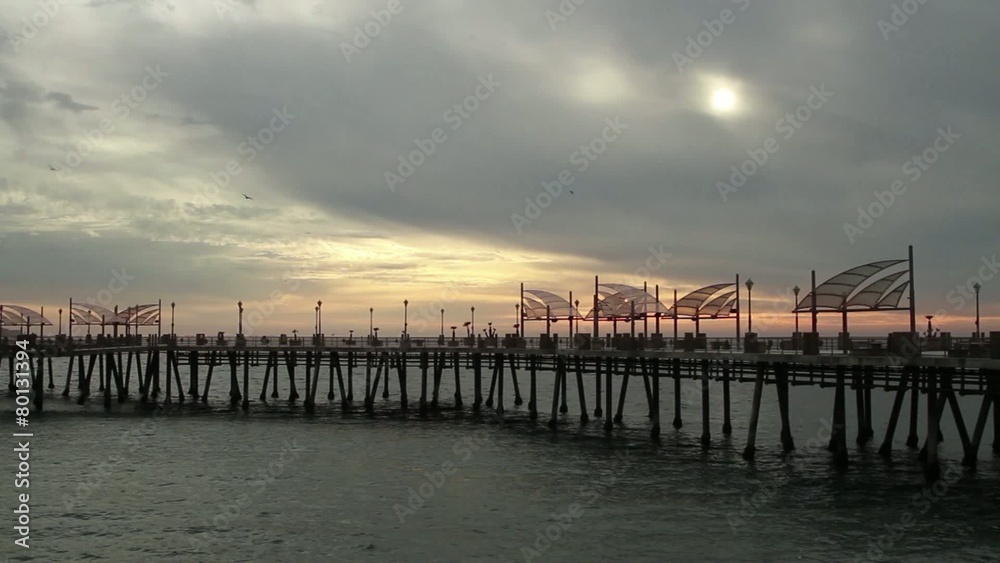 Beautiful skies over the pier at Redondo Beach in Los Angeles, California, USA, with silhouetted people walking on the pier and some birds flying past. Two clips. Beautiful skies over the pier at Redondo Beach in Los Angeles, California, USA, with silhouetted people walking on the pier and some birds flying past. Two clips.