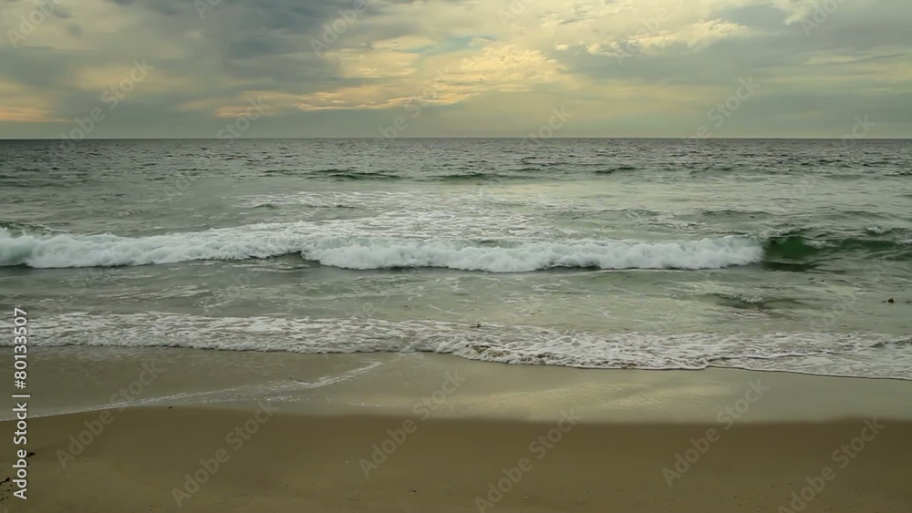 Beautiful beach with small waves lapping on the shore in California, USA.
