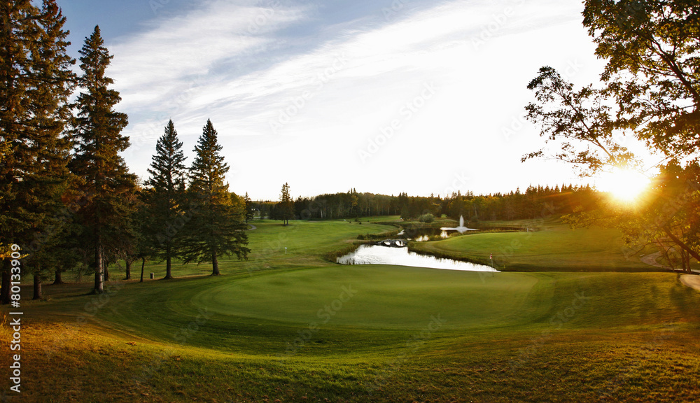 A golf course fairway with a water hazard. A golf course fairway with a water hazard.